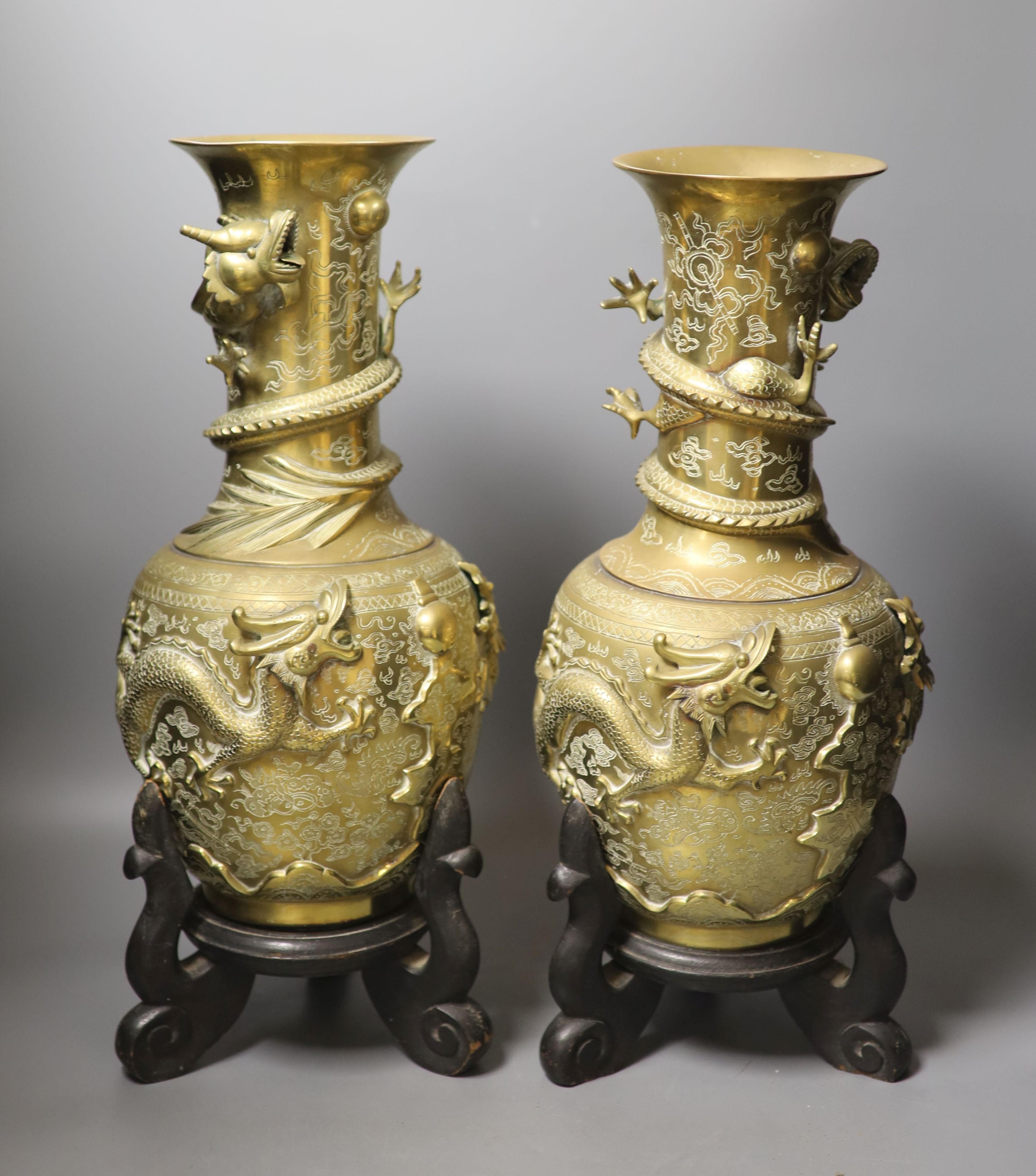 A pair of large Chinese bronze vases on stands, 45.5 cms high including stands